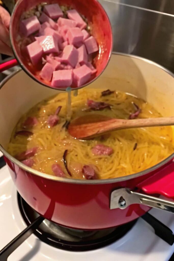 Beef and water added to the pot over sautéed onions